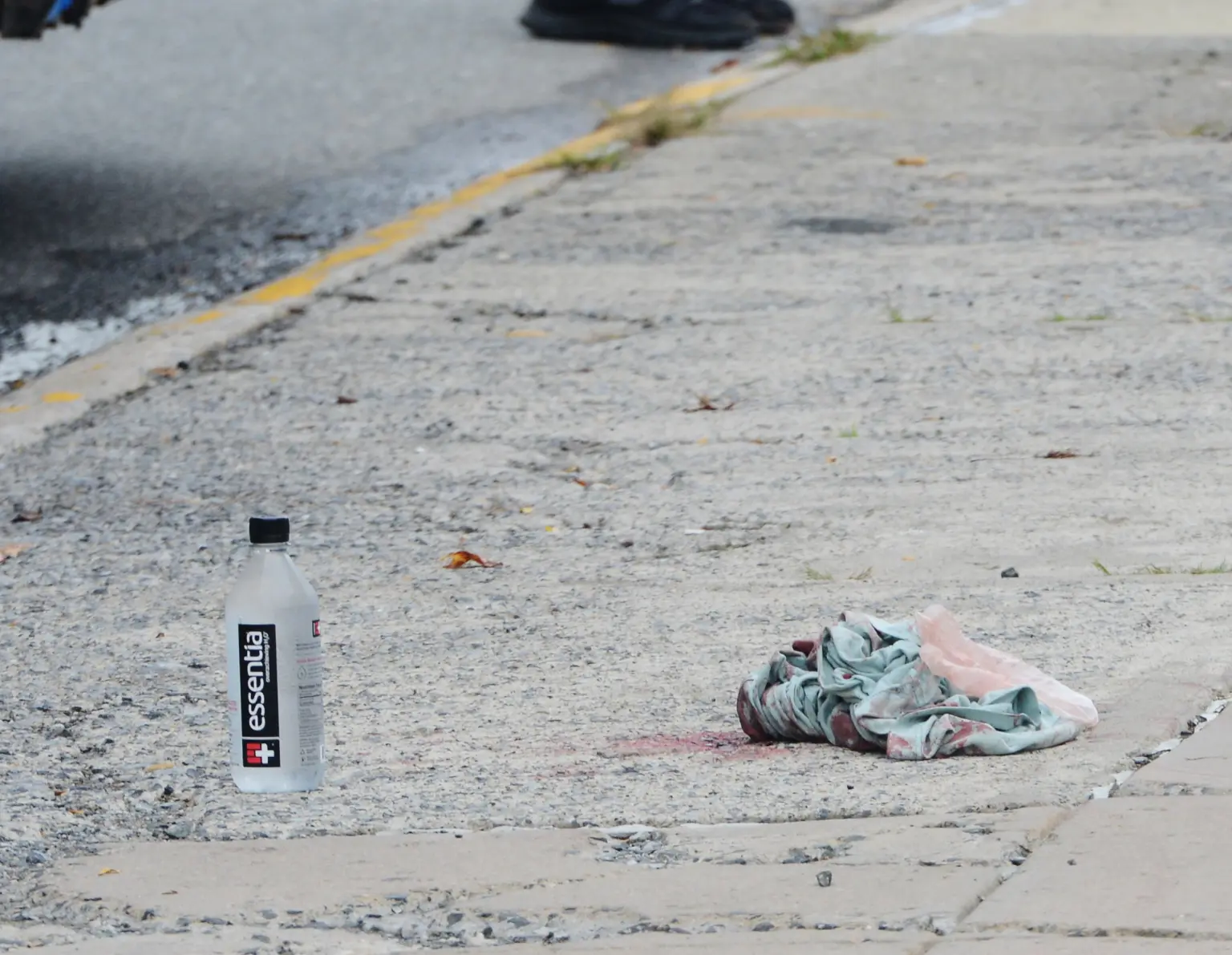 A piece of cloth lies on the sidewalk at the scene where a teen was killed on a city bus at Littleton Avenue and Hylan Boulevard. 